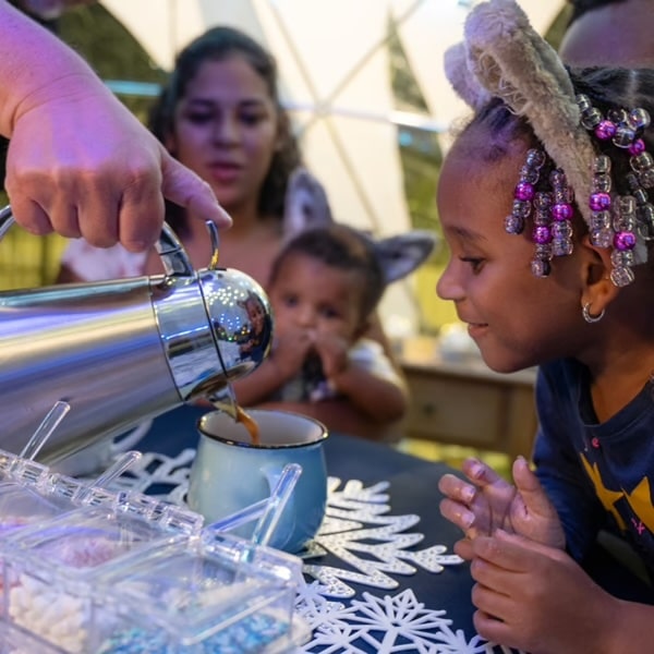 A family enjoys a hot chocolate bar at Great Wolf Lodge's SNOWLAND.